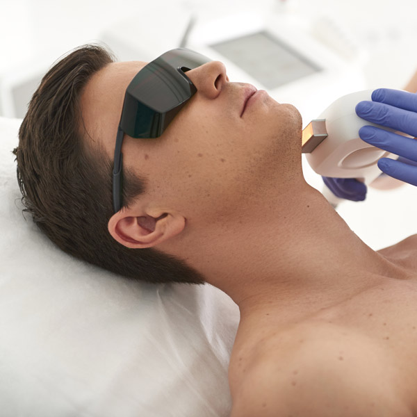 man getting laser hair removal treatment