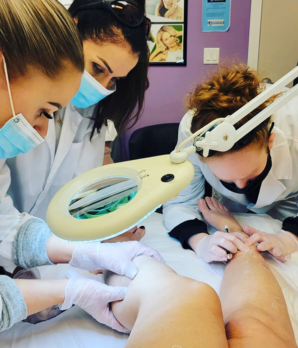 students working on patients legs